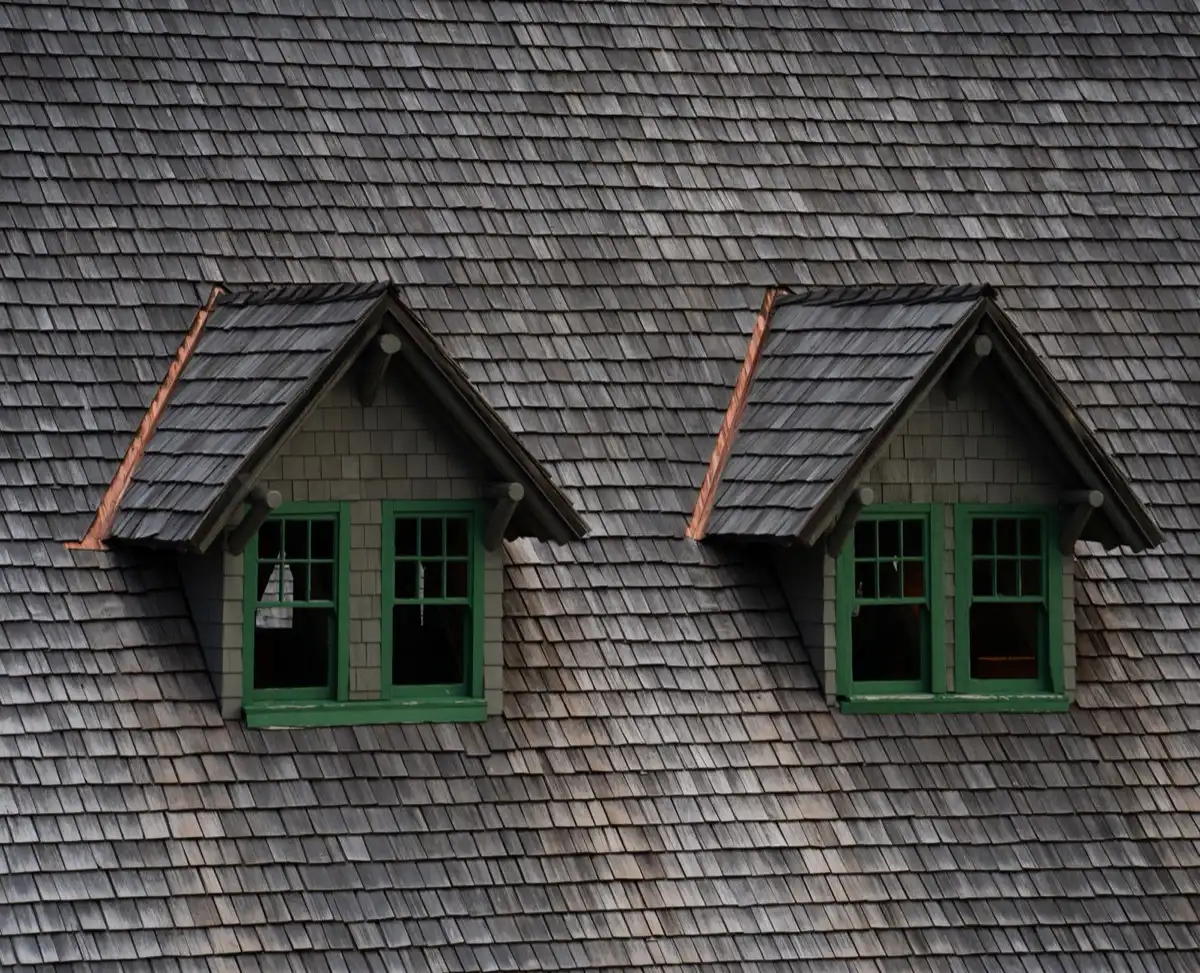 Dormers on a shingle roof in Nashville, TN, where step flashing and kickout flashing carry water past the walls